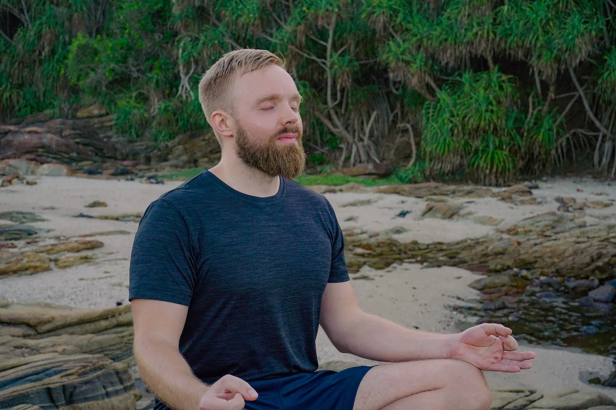 meditating man on the beach